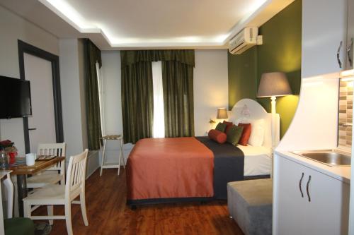 伊斯坦布尔Hotel Taksim Home的酒店客房带一张床和一个厨房