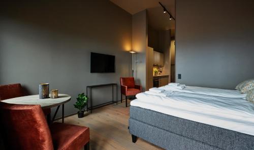 贝特斯托尔Riddergaarden的酒店客房带一张床、一张桌子和椅子