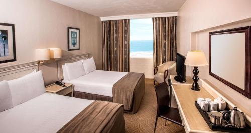 德班宜容格尼玛哈拉尼酒店的酒店客房,设有两张床和镜子