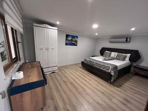 PelitliBayraktar apart的一间卧室配有一张床,铺有木地板