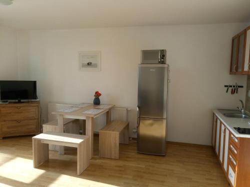 利普托斯基米库拉斯利普托公寓的厨房配有不锈钢冰箱和桌子