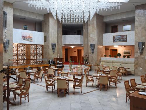 基辅纳兹安娜尼酒店的一间带桌椅和吊灯的餐厅