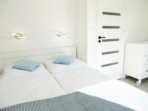 弗瓦迪斯瓦沃沃Domki Kapitalne的一间卧室配有一张带两个枕头的床