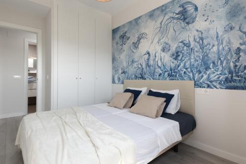 贝纳哈拉菲Sueño Playa的卧室配有一张大床,墙上挂有绘画作品