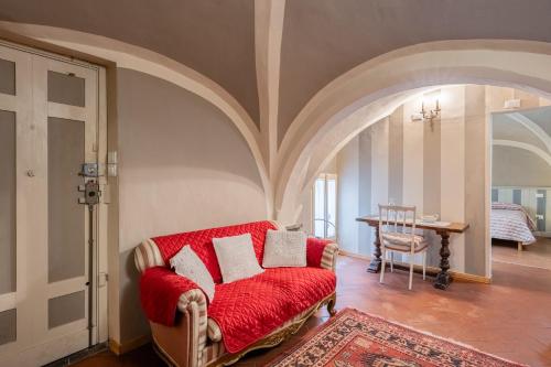 皮斯托亚Residenza Gatteschi的客厅配有红色的沙发和桌子