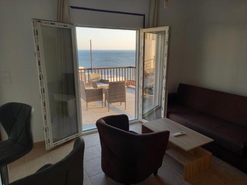 巴特斯欧AMPELOS ANDROS的带沙发的客厅,享有海景