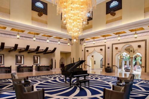 多哈Sharq Village & Spa, a Ritz-Carlton Hotel的大堂的三角钢琴,吊灯