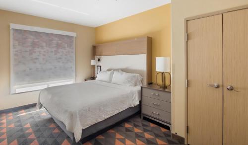 Bellmead韦科西北智选假日套房酒店的一间卧室设有一张大床和一个窗户。