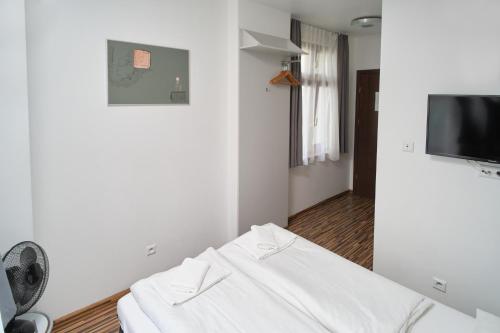 弗罗茨瓦夫阿奇拉住宿加早餐酒店的客房设有白色沙发和平面电视。