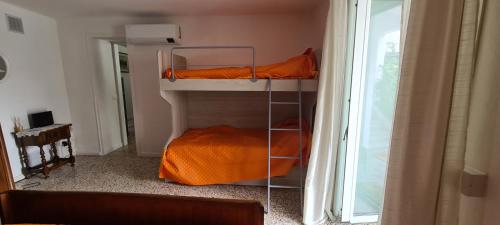 切尔诺比奥Da Ersilia的客房设有两张双层床和一扇窗户。