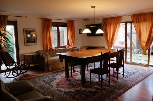 格丁尼亚Apartament Bilard nad Bałtykiem的一间带木桌和椅子的用餐室