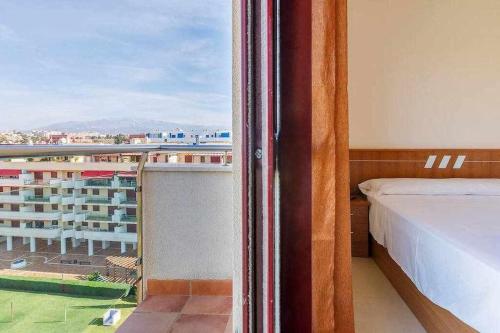 托雷德尔马尔A&N La Vega 3的一间卧室设有一张床,享有阳台的景色