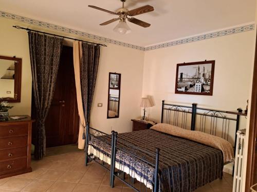 CardileLa Casa Di Lidia的一间卧室配有一张床和吊扇