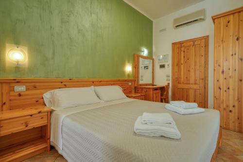 拉齐塞Camere da Mirella的一间卧室配有一张床,上面有两条毛巾