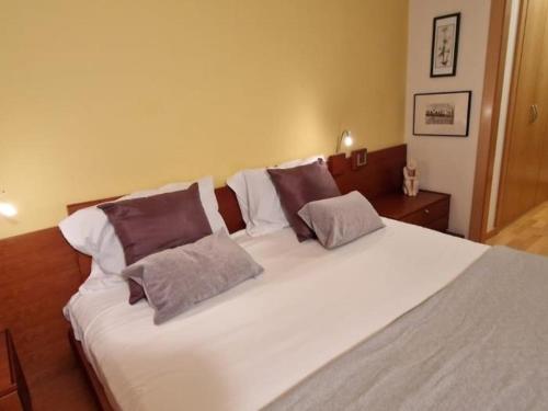 萨瓦德尔Homing Sabadell 73的一张带三个枕头的大白色床