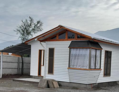 PutaendoEncanto Rural - Casa de campo para disfrutar y olvidar el estrés的一间白色的小房子,设有大窗户