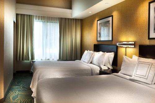 格雷普韦恩达拉斯机场北/格雷普韦恩春季山丘套房酒店的酒店客房设有两张床和窗户。