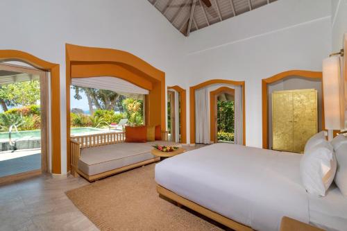 塔可克海滩Phulay Bay, A Ritz-Carlton Reserve的一间带大床的卧室和一个阳台
