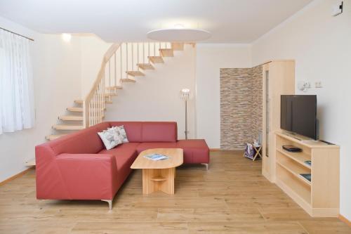 沃尔特湖畔韦尔登Ferienparadies Truppe的客厅配有红色沙发和电视