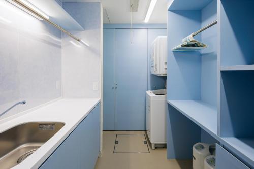 白马村AMO 54 by Hakuba Hospitality Group的浴室设有蓝色的墙壁和水槽