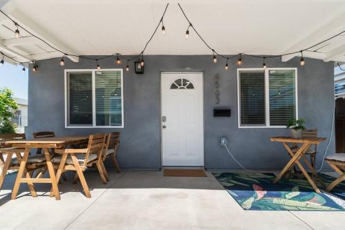 圣地亚哥Urban Oasis: San Diego Bungalow Escape的一个带桌椅的庭院和一扇白色门