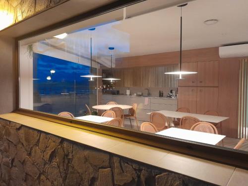 扎鲁亚斯Kein Hostel的一间带桌椅的用餐室和大窗户