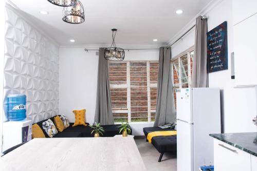 Zomba2 bedroom modern house in Zomba的厨房以及带沙发和冰箱的客厅。