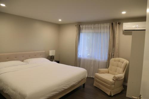 苏克Waterfront Paradise的卧室配有床、椅子和窗户。