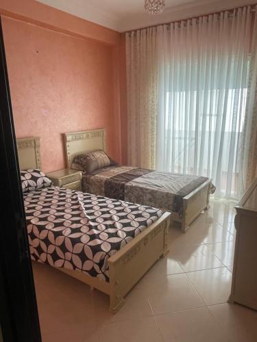 得土安Appartement De Luxe A Wilaya De Tetouan的卧室设有两张粉红色的床铺。