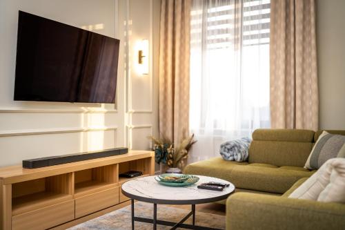 伊诺弗罗茨瓦夫Apartamenty Poznańska 15的客厅配有电视、沙发和桌子