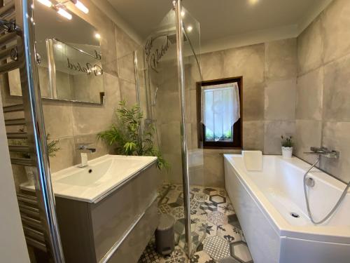新堡Dieu L'Amour - Molinard的带浴缸、水槽和淋浴的浴室