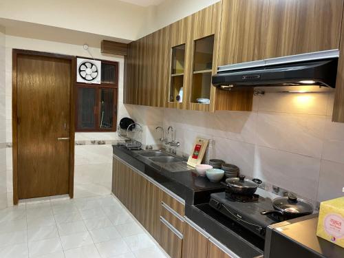 达卡Gulshan Stylish 3 bedroom Luxury Apartment in Prime location的厨房配有水槽和炉灶 顶部烤箱