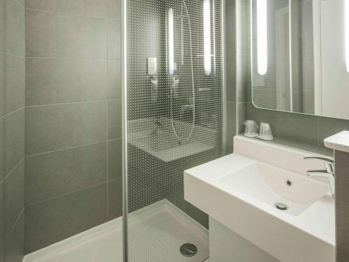 希灵登伦敦希思罗机场宜必思酒店的带淋浴、盥洗盆和镜子的浴室