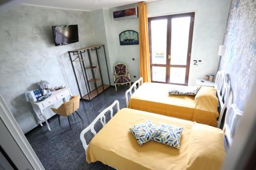 San Martino In StradaB & B L'almanacco的酒店客房设有两张床和窗户。