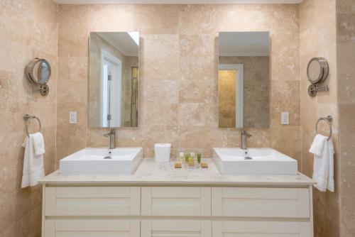 圣菲利普白鹤度假村的浴室设有2个水槽和2面镜子