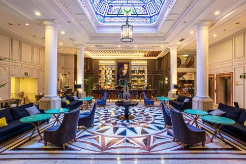 托莱多欧仁妮德蒙蒂若傲途格精选酒店的大堂设有桌椅和吊灯。