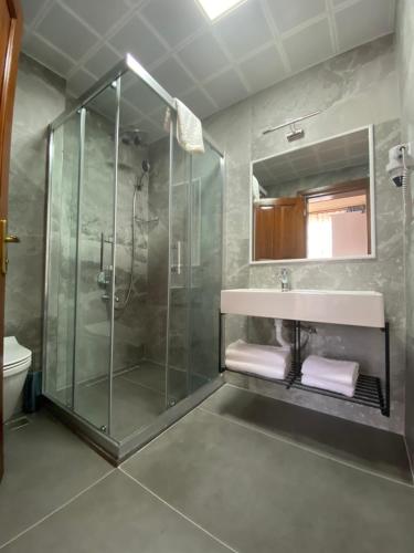 安塔利亚Ulivo Hotel的一间带玻璃淋浴和水槽的浴室