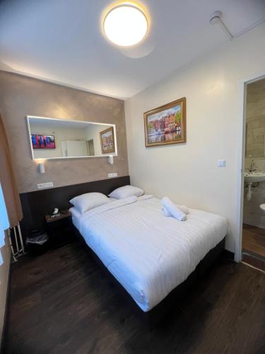 阿姆斯特丹Orange Tulip Hotel的一间卧室配有一张大床和镜子