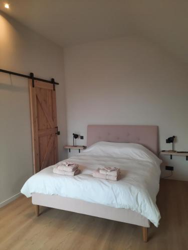 KruisemKomo Hill Stays - guestroom Komo Cosy的一间卧室配有一张床,上面有两条毛巾