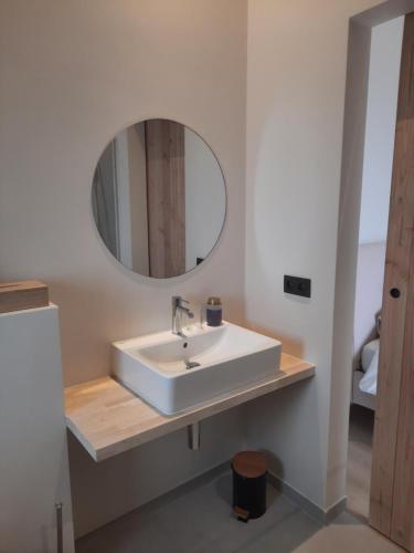 KruisemKomo Hill Stays - guestroom Komo Cosy的浴室设有白色水槽和镜子