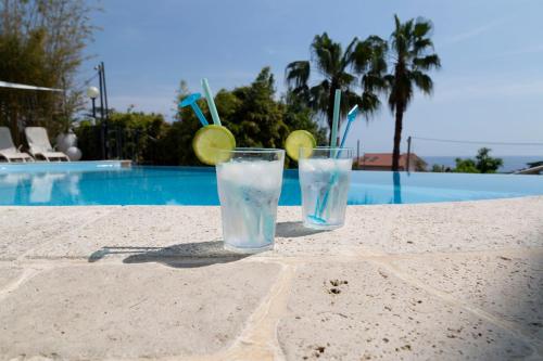 阿尔比索拉马里纳Casa Milena elegante dimora con piscina privata的游泳池畔桌子上两杯水