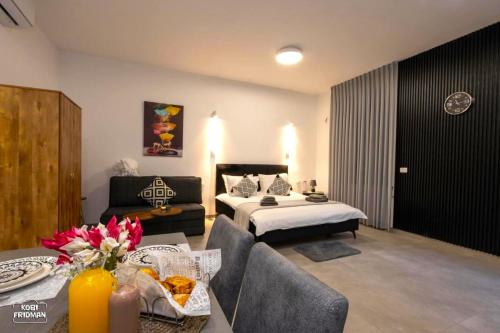 马格达拉Yalarent Melody- Suites with privat pools的酒店客房带一张床、一张桌子和椅子