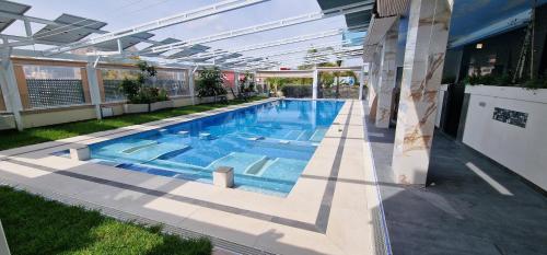 菲内斯特拉特APARTAMENTOS OASIS DE LA CALA的庭院内的游泳池,配有开放式遮阳伞
