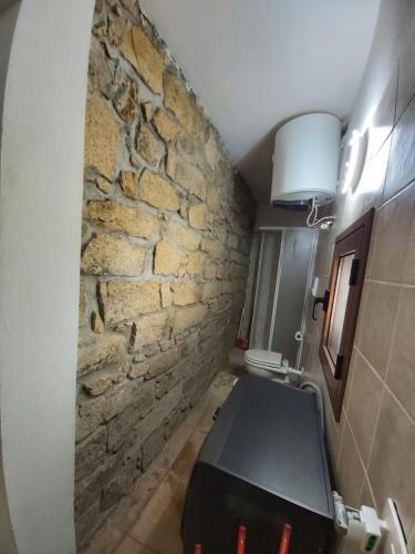 La Dimora degli Dei的一间带石墙和桌子的浴室