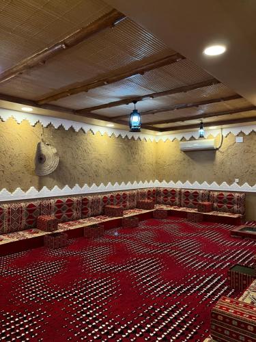 塔诺马استراحة الورود的大型客房,位于大楼内,设有大型红色地板
