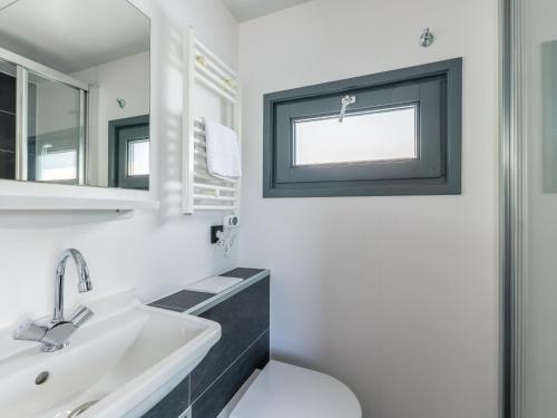 厄伊特海斯特Tiny houseboat Uitgeest I的白色的浴室设有水槽和镜子