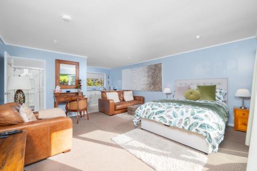 拉塞尔Pukeko Nest的一间卧室设有一张床和一间客厅。