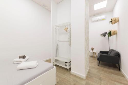 科尔多瓦Home up Qurtuba的白色卧室配有镜子和椅子