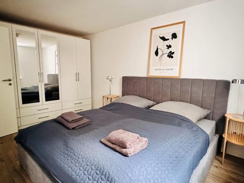施塔德Der Stader Hafenblick的一间卧室配有蓝色的床和2条毛巾