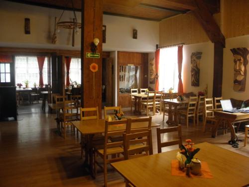 索布特卡Dom Turysty Pod Wieżycą的一间空餐厅,配有木桌和椅子